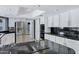 Kitchen with black countertops, stainless steel appliances, white cabinets, and tile floors at 8936 N 80Th Pl, Scottsdale, AZ 85258