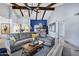 Bright living room with vaulted ceilings, wood beams, neutral furniture, and an open floor plan at 8936 N 80Th Pl, Scottsdale, AZ 85258