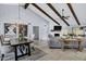 Bright living room featuring vaulted ceilings, exposed beams, and a fireplace at 8936 N 80Th Pl, Scottsdale, AZ 85258
