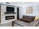 Modern living room with contemporary fireplace, large TV, and comfortable sectional sofa at 8936 N 80Th Pl, Scottsdale, AZ 85258