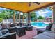Inviting covered patio featuring outdoor seating, tiled floor, and a serene pool view at 8936 N 80Th Pl, Scottsdale, AZ 85258