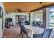 Covered patio with ample seating, providing a comfortable outdoor living space overlooking the lush backyard and pool at 8936 N 80Th Pl, Scottsdale, AZ 85258