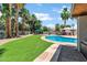 Lush backyard showcasing a sparkling pool, artificial grass, and a covered gazebo for ultimate relaxation at 8936 N 80Th Pl, Scottsdale, AZ 85258