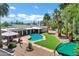 Beautiful backyard featuring a sparkling pool, lush green grass, and mature palm trees at 8936 N 80Th Pl, Scottsdale, AZ 85258