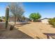Expansive backyard featuring mature landscaping, a shed, and a covered patio at 9051 E Grandview Dr, Mesa, AZ 85207