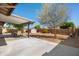 Spacious backyard with a covered patio, desert landscaping, and plenty of space for outdoor activities at 9051 E Grandview Dr, Mesa, AZ 85207
