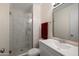 Modern bathroom featuring a glass-enclosed shower, a white vanity, and elegant fixtures at 9051 E Grandview Dr, Mesa, AZ 85207