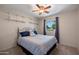 Comfortable bedroom with neutral walls, carpet, stylish bedding, and a bright window at 9051 E Grandview Dr, Mesa, AZ 85207