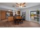 Dining room with hardwood floors, casual lighting, and a view of the outdoor patio through a sliding door at 9051 E Grandview Dr, Mesa, AZ 85207