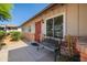 Inviting front porch with brick accents, a charming bench, and a secure front door at 9051 E Grandview Dr, Mesa, AZ 85207