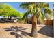 Charming home featuring a spacious driveway, lush trees, and a desert-landscaped front yard at 9051 E Grandview Dr, Mesa, AZ 85207