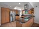 Bright kitchen featuring stainless steel appliances, a modern range hood, and a skylight providing natural light at 9051 E Grandview Dr, Mesa, AZ 85207