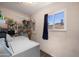 Well-lit laundry room with a window offering views of the outdoors and ample storage shelving at 9051 E Grandview Dr, Mesa, AZ 85207