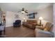 Cozy living room with hardwood floors, ceiling fan, comfortable seating, and stylish decor at 9051 E Grandview Dr, Mesa, AZ 85207