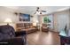 Cozy living room featuring hardwood floors, comfortable seating, and a large window with natural light at 9051 E Grandview Dr, Mesa, AZ 85207