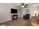Cozy living room with mounted TV, comfortable seating, and hardwood flooring at 9051 E Grandview Dr, Mesa, AZ 85207
