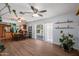 Open concept living space flows into the kitchen, featuring hardwood floors and a modern ceiling fan at 9051 E Grandview Dr, Mesa, AZ 85207