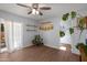 Bright living space with hardwood floors, modern ceiling fan, sliding doors to patio, and neutral walls at 9051 E Grandview Dr, Mesa, AZ 85207