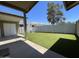 Expansive backyard featuring artificial turf, a block wall, and a covered patio at 9221 N 48Th Dr, Glendale, AZ 85302