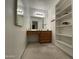 Bathroom featuring a vanity with a mirror and well organized shelves for storage at 9221 N 48Th Dr, Glendale, AZ 85302
