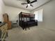 This carpeted bedroom has a bunk bed and a desk at 9221 N 48Th Dr, Glendale, AZ 85302