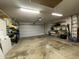 Well-lit two car garage with storage shelves and a modern automatic door system at 9221 N 48Th Dr, Glendale, AZ 85302