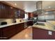 Modern kitchen with stainless steel appliances, granite countertops, and wood cabinets at 9221 N 48Th Dr, Glendale, AZ 85302