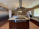 Gourmet kitchen featuring a central island with a cooktop and granite countertops at 9221 N 48Th Dr, Glendale, AZ 85302
