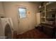 Laundry room with Bosch washer/dryer, door to the outside, and shelving at 9221 N 48Th Dr, Glendale, AZ 85302