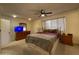 Comfortable main bedroom with a plush bed, ceiling fan, and ample natural light from the window at 9221 N 48Th Dr, Glendale, AZ 85302