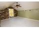 Attic bedroom with wood paneled window alcove and ceiling fan at 937 E 6Th Ave, Mesa, AZ 85204