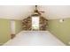 Bright bonus room features a wood accent wall, ceiling fan, and a window offering ample natural light at 937 E 6Th Ave, Mesa, AZ 85204