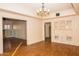 Open dining room featuring built-in cabinets, wood floors, chandelier, and archways at 937 E 6Th Ave, Mesa, AZ 85204