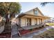 Inviting single-story home with a covered porch, established plants, and mature trees at 937 E 6Th Ave, Mesa, AZ 85204