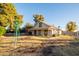 Charming home with a windmill in the yard surrounded by lush greenery offering a serene setting at 937 E 6Th Ave, Mesa, AZ 85204
