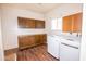 Spacious laundry room with washer, dryer, storage cabinets, and new flooring at 937 E 6Th Ave, Mesa, AZ 85204