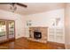 Cozy living room with hardwood floors, fireplace, built-in bookshelves, and French doors at 937 E 6Th Ave, Mesa, AZ 85204