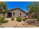 House exterior view of gravel backyard with desert landscaping and covered patio at 9535 E Tupelo Ave, Mesa, AZ 85212