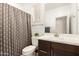 Bright bathroom featuring a large vanity, modern fixtures, and a patterned shower curtain at 9535 E Tupelo Ave, Mesa, AZ 85212