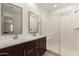 Modern bathroom featuring a double sink vanity, walk-in shower, and bright natural lighting at 9535 E Tupelo Ave, Mesa, AZ 85212