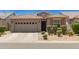 Charming single-story home featuring a two-car garage and meticulously maintained front yard at 9535 E Tupelo Ave, Mesa, AZ 85212
