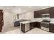 Modern kitchen featuring stainless steel appliances and an open layout into the living room at 9535 E Tupelo Ave, Mesa, AZ 85212