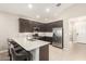 Well-lit kitchen featuring stainless steel appliances and dark wood cabinetry at 9535 E Tupelo Ave, Mesa, AZ 85212