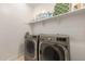 Laundry room featuring modern washer and dryer units with shelving for storage at 9535 E Tupelo Ave, Mesa, AZ 85212