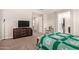 Another angle of the main bedroom reveals a large TV and neutral carpet at 9535 E Tupelo Ave, Mesa, AZ 85212