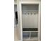 Functional mudroom featuring white trim, coat hooks, a dark wood bench, and cubbies for storage at 9535 E Tupelo Ave, Mesa, AZ 85212