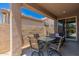 Back patio with table, chairs and view of backyard through sliding glass doors at 9535 E Tupelo Ave, Mesa, AZ 85212