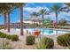 Community pool with water slide, shaded seating, and lush landscaping, perfect for Gathering fun at 9535 E Tupelo Ave, Mesa, AZ 85212