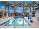 Inviting community pool area with lounge chairs, shaded cabanas, and accessible lift for residents' enjoyment at 9535 E Tupelo Ave, Mesa, AZ 85212