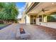 An open patio with a cozy fire pit and a covered area with a ceiling fan and mounted TV creates an inviting outdoor space at 970 W Zion Way, Chandler, AZ 85248